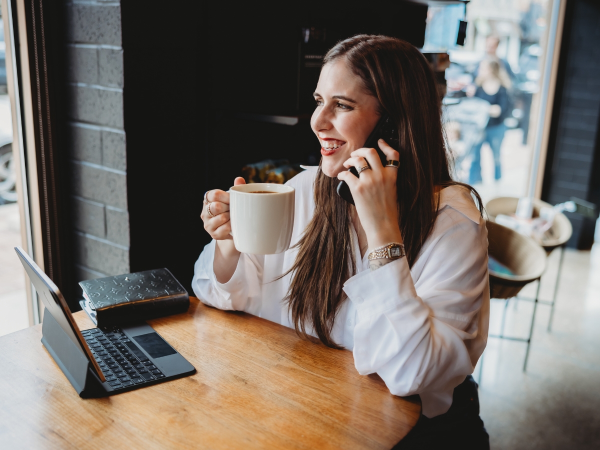 Social media manager on phone with small business owner discussing when to hire help